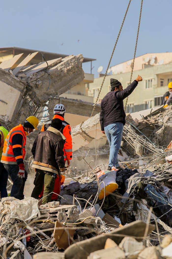 Rescue workers search for survivors in urban earthquake debris.